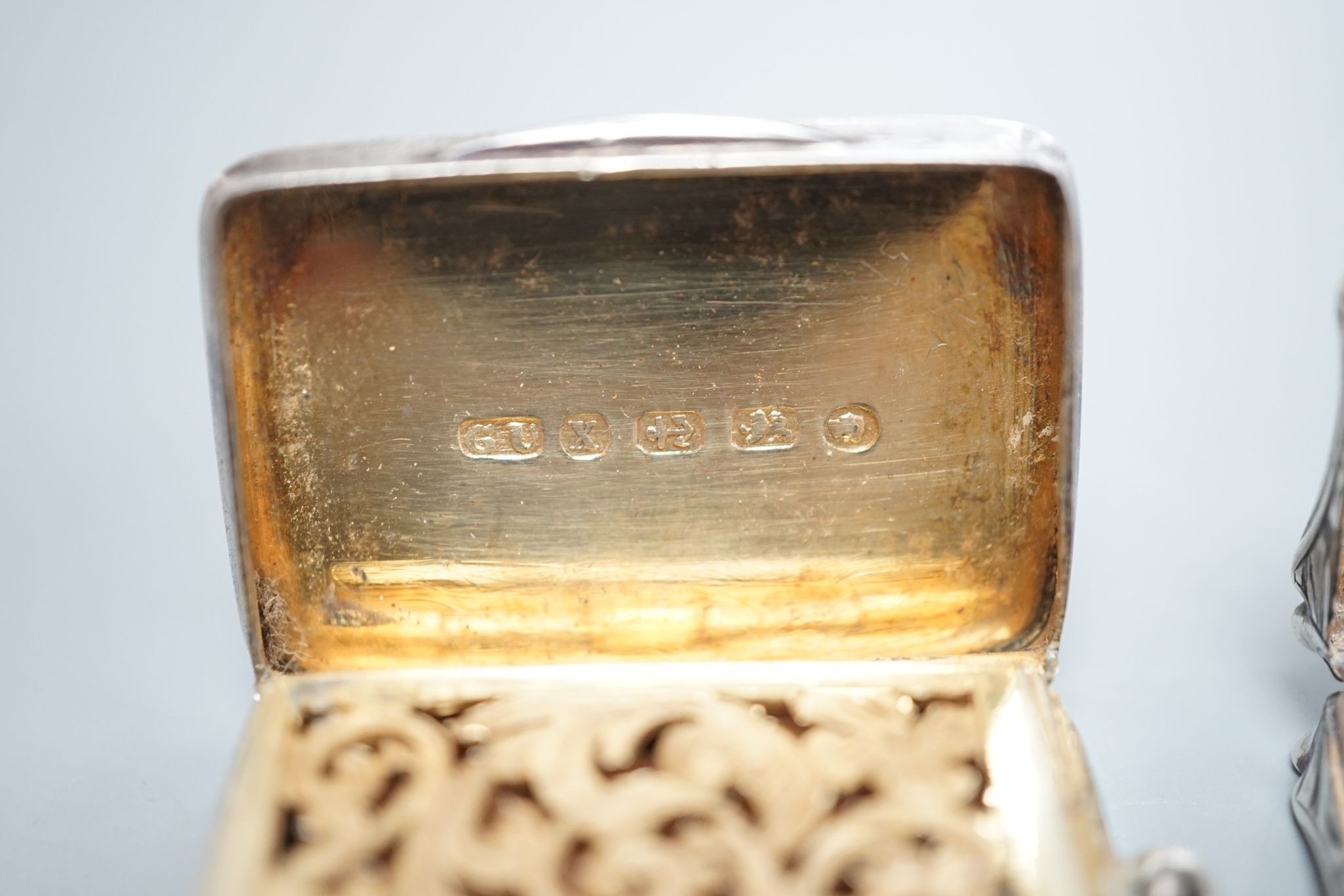 An early Victorian engraved silver shaped rectangular vinaigrette, by Nathaniel Mills, Birmingham, 1844, 31mm and a later silver vinaigrette by George Unite.